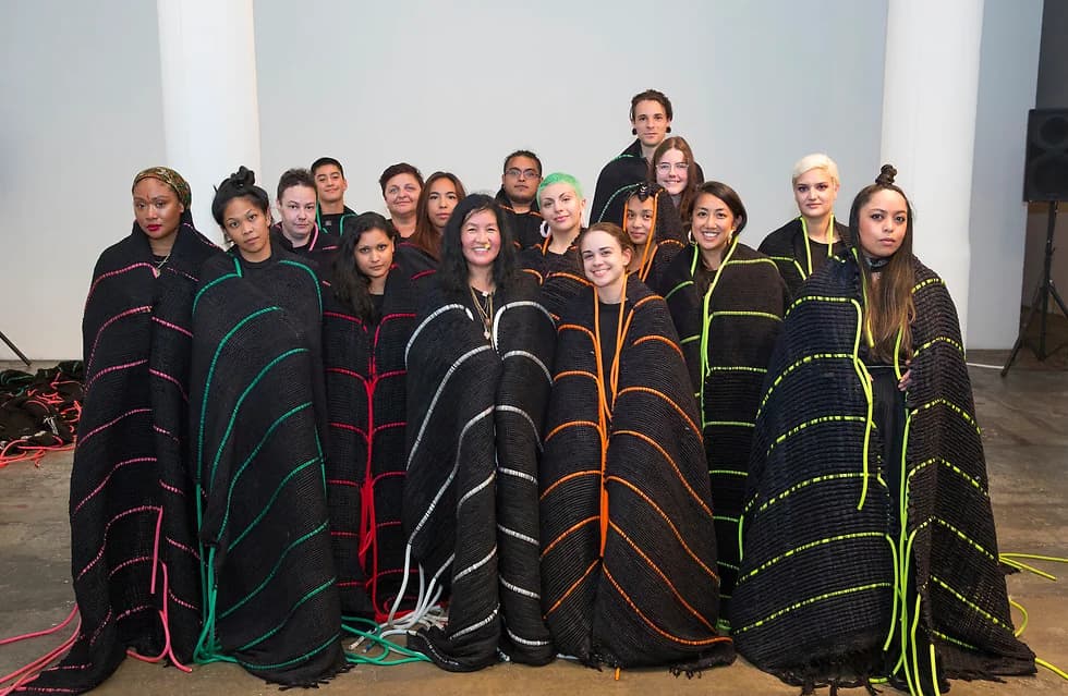 TechnoLove performer inside woven cocoon, studio view