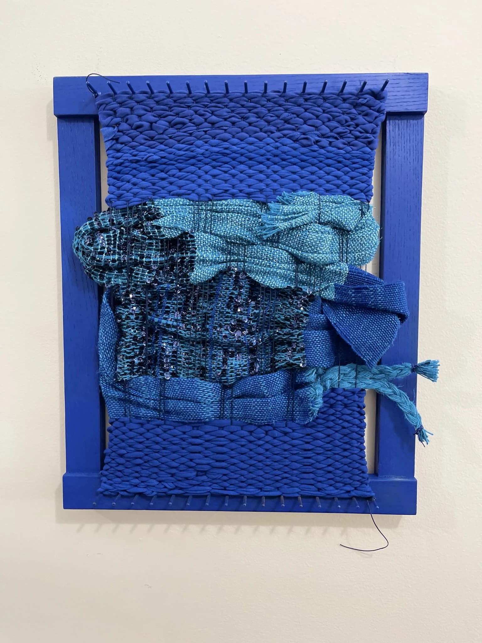 Handwoven textile art piece with natural fibers