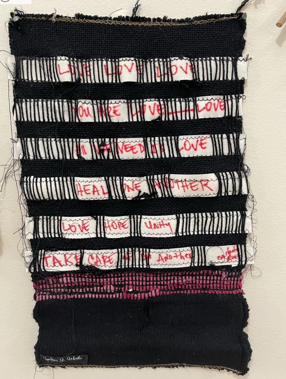 Fiber art detail highlighting thread and knotwork